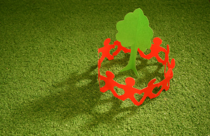 Paper chain people caring for the planet