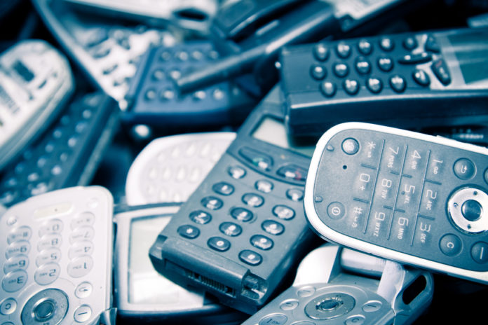 scatered old cellphones color processed blue