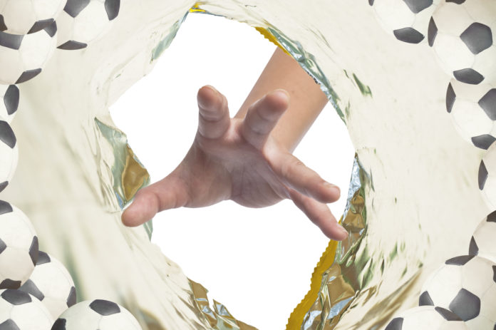 Hand catch ball in plastic snack pack